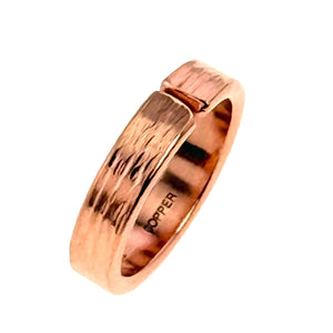 7 of 9: Angled side view of a polished 5.5mm bark copper cuff ring standing upright on a white background, showing the textured outer surface, open cuff design, rounded edges, smooth interior, and copper stamp.