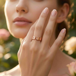 4 of 9: Woman wearing a 5.5mm bark copper cuff ring on her finger in a softly lit garden setting, showing the open front, hand applied texture, warm polished copper color, and easy everyday styling.