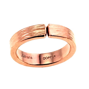 5 of 9: Rear view of a handmade 5.5mm bark textured copper cuff ring on a white background, showing the open gap, polished edges, warm rose copper color, smooth inner band, and stamped John S. Brana and copper marks.