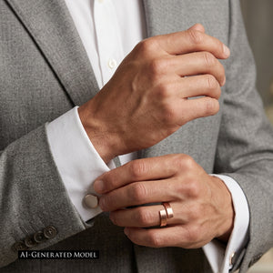 8 of 9: Close up of a matte copper bypass ring worn on a man’s finger while adjusting a white shirt cuff with a gray suit jacket, showing warm copper color and clean modern styling.  AI Generated Model.
