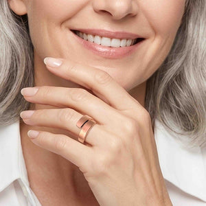 4 of 9: Woman wearing a matte copper bypass ring on her finger with a white blouse, showing the ring’s warm copper tone, clean open design, and modern everyday style.