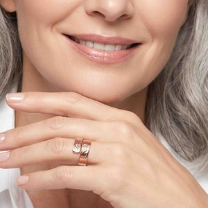 6 of 9: Smiling woman wearing a 5.5mm texturized copper bypass ring, styled as an everyday handmade copper ring with a polished finish, textured surface, and open bypass design.