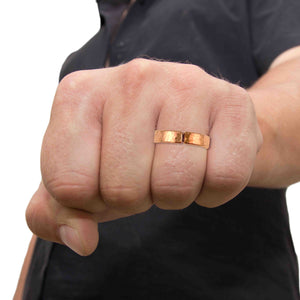 2 of 9: Man wearing the 5mm Hammered Copper Cuff Ring on his ring finger, showcasing its bold and unisex style.