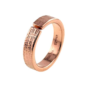 3 of 8: Close-up product image of a 5mm linen textured copper cuff ring with an open adjustable band. The outer surface features a hand applied woven fabric pattern with a polished finish, while the interior is smooth and stamped “JSBrana” and “COPPER.” Crafted from solid raw copper with a warm rose gold tone, the 2mm thick band is shown against a clean white background.