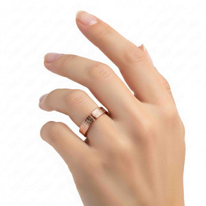 4 of 8: Close-up of a hand wearing a 5mm linen textured copper cuff ring on the ring finger against a clean white background. The open band design features a small gap at the top and a woven fabric pattern engraved on the outer surface. The solid copper ring has a warm rose gold tone with a polished finish, highlighting its slim 5mm width and modern unisex style.