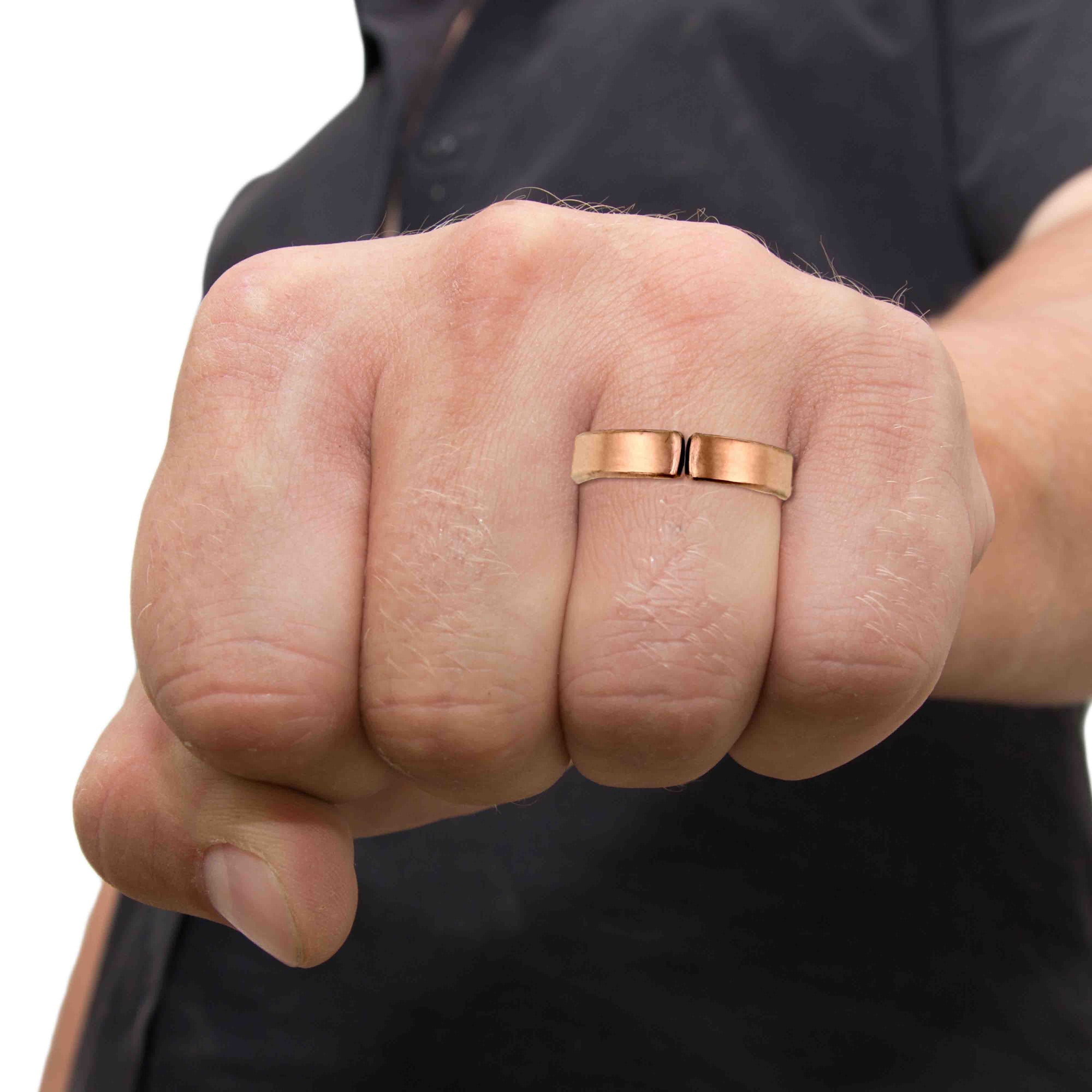 5mm Matte Copper Cuff Ring on a man's finger with a blurred background