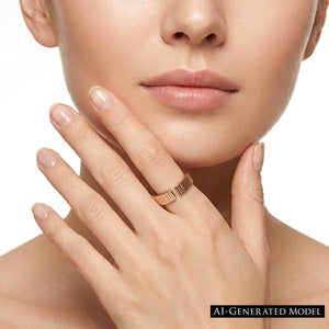 8 of 9: Woman wearing a 6mm chased bronze cuff ring on her finger while resting her hand near her chin. The polished bronze band has an open cuff design and hand applied vertical texture. Neutral manicure and white background keep the focus on the ring.  AI Generated Model.