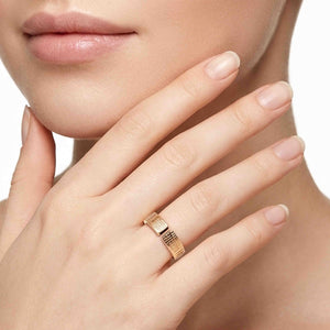 6 of 9: Close view of the 6mm linen bronze cuff ring worn on a woman’s finger, showing the open cuff shape, hand applied linen texture, polished bronze glow, and delicate modern styling.