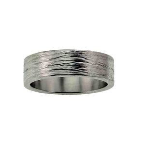 3 of 8: Front view of a 7mm wide stainless steel flat band ring featuring a hand carved bark texture across the exterior. The organic pattern resembles natural tree bark with subtle grooves and polished highlights that reflect light. The ring has flat outer edges and a smooth, shiny interior. Displayed centered against a clean white background, showcasing its modern unisex design and balanced profile.