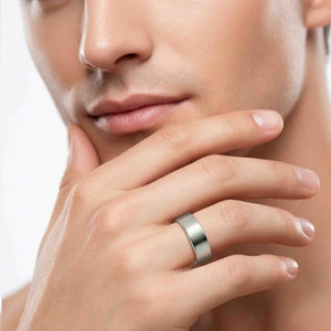 6 of 8: Man wearing a 7mm matte stainless steel flat band ring on his finger, styled with a clean modern look against a close cropped face and hand pose.