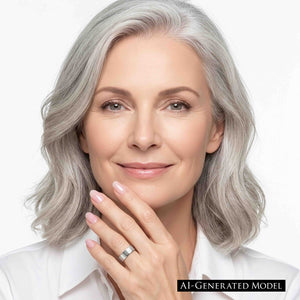 4 of 9: Polished stainless steel flat band ring worn on a woman’s finger as she rests her hand near her chin, featuring a wide smooth profile, reflective silver finish, and clean modern style with a white shirt and soft white background.  AI Generated Model.