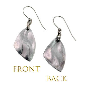 3 of 7: Front and back view of brushed aluminum flame petal dangle earrings with sculpted die struck detailing. The front shows curved petal like grooves that catch light with a soft satin finish, while the back has a smooth brushed surface. Each lightweight aluminum drop hangs from stainless steel French ear wires, forming a modern leaf or flame inspired shape.