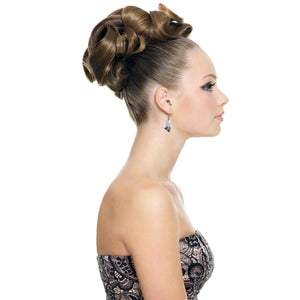 5 of 7: Woman in side profile wearing brushed aluminum flame petal dangle earrings. The lightweight silver tone earrings feature sculpted curved detailing and hang from stainless steel French ear wires. Her hair is styled in an elegant updo, highlighting the small petal shaped earrings that dangle just below the earlobe. She wears a strapless patterned dress against a clean white background.