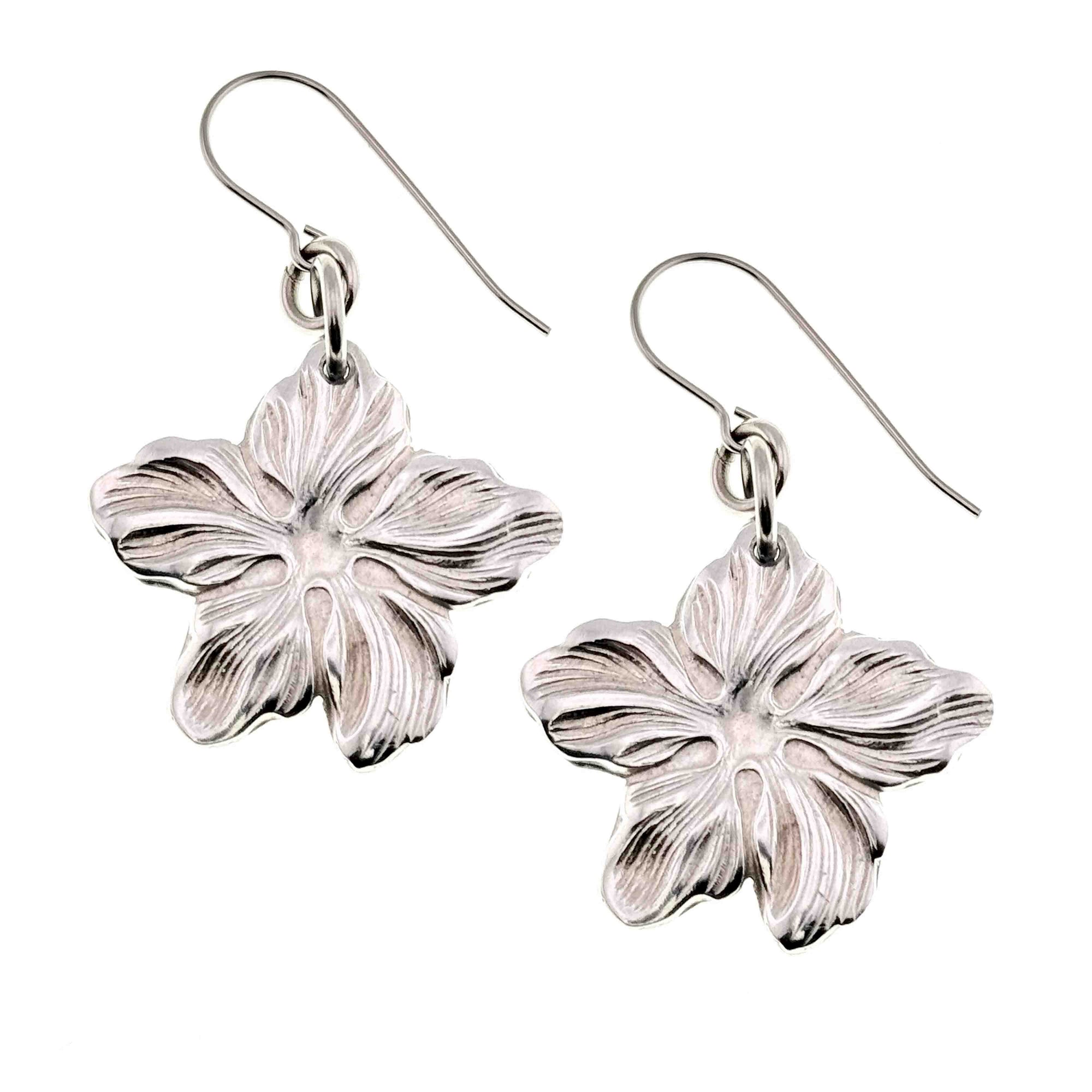 A Pair of Aluminum Hibiscus Flower Dangle Earrings on a White Background
