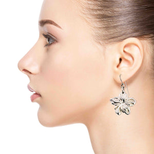 2 of 7: A Fashionable Woman Wearing Aluminum Hibiscus Flower Dangle Earrings