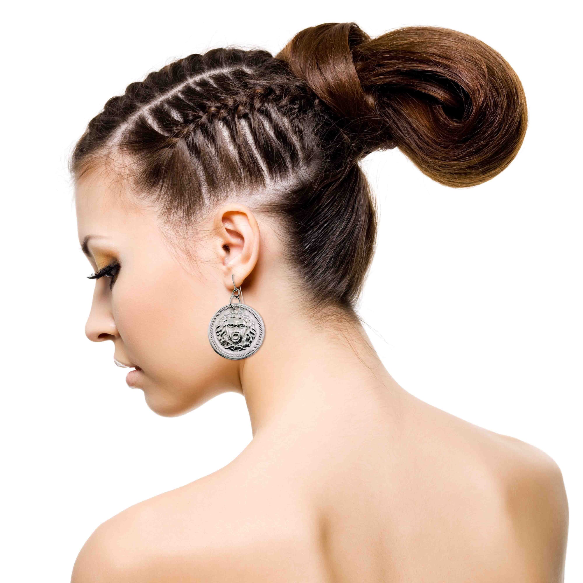 Woman with braided hair styled into a bun on a white background wearing Aluminum Medusa Disc Drop Earrings