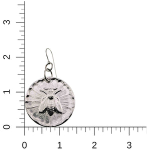 5 of 7: Aluminum Queen Bee Disc Drop Earrings on a ruler for scale on a white background