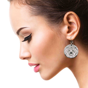 4 of 7: Close-up of a woman wearing Aluminum Vampire Bat Disc Dangle Earrings with a detailed design.