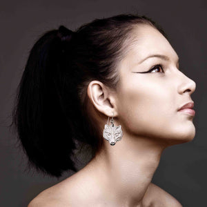 4 of 7: A Elegant Woman Wearing Aluminum Wolf Head Earrings