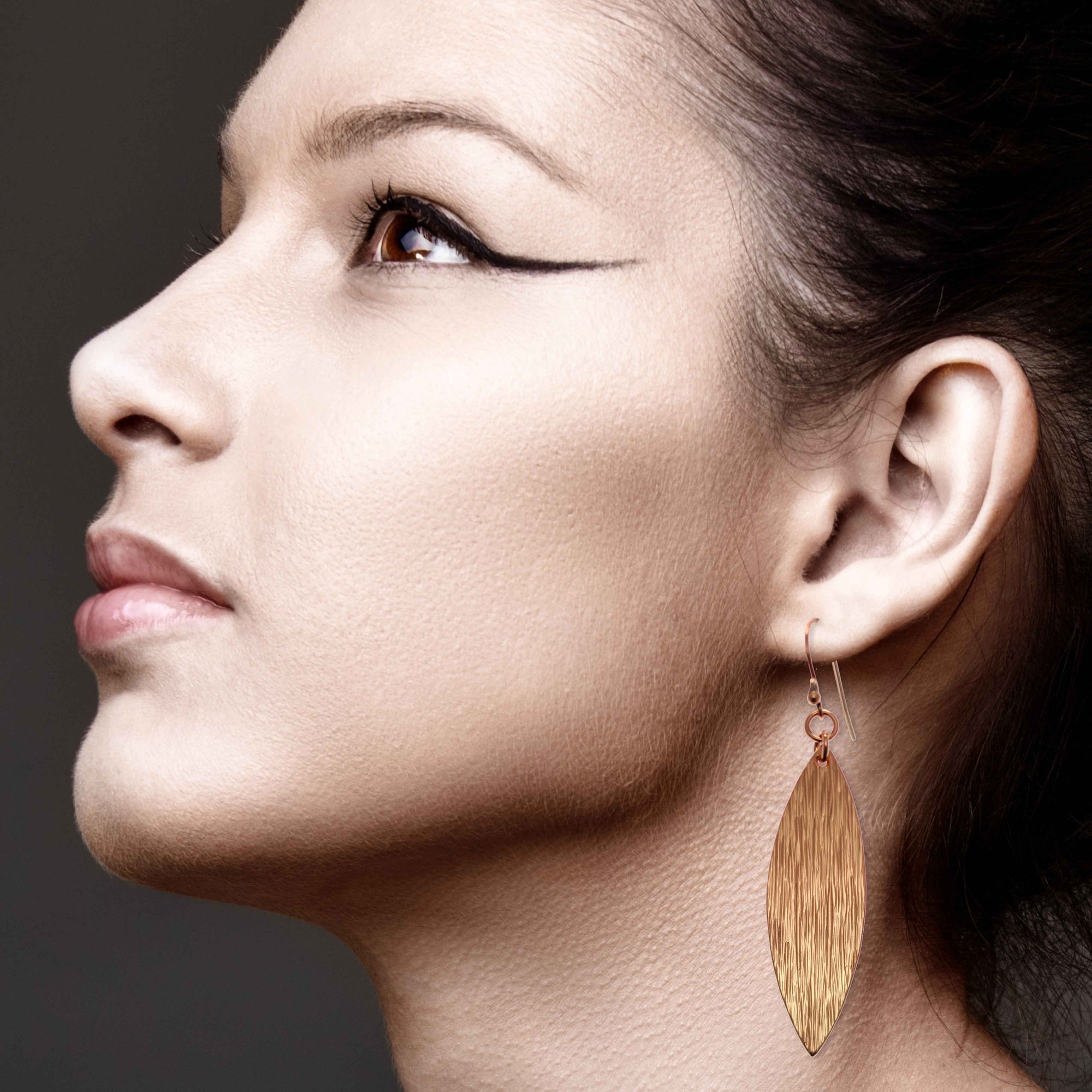 Elegant Woman Wearing Bark Embossed Copper Leaf Drop Earrings