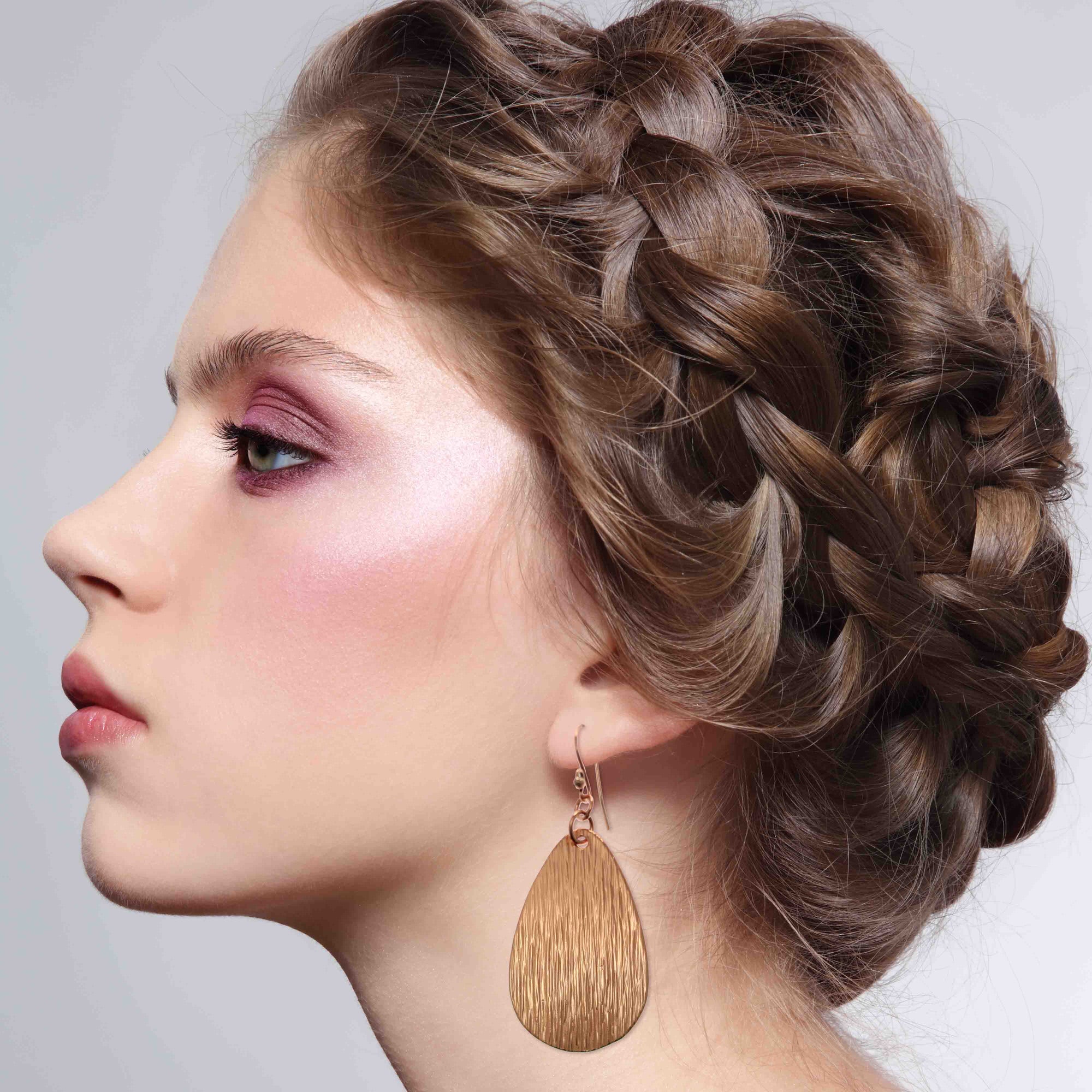 Elegant Woman Wearing Bark Embossed Large Teardrop Earrings