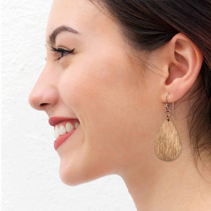 7 of 8: Smiling Woman Wearing Bark Embossed Small Teardrop Earrings