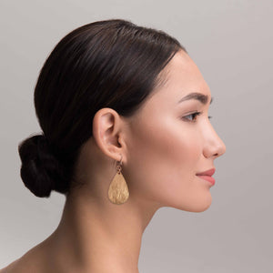 4 of 8: Elegant Woman Wearing Bark Embossed Small Teardrop Earrings
