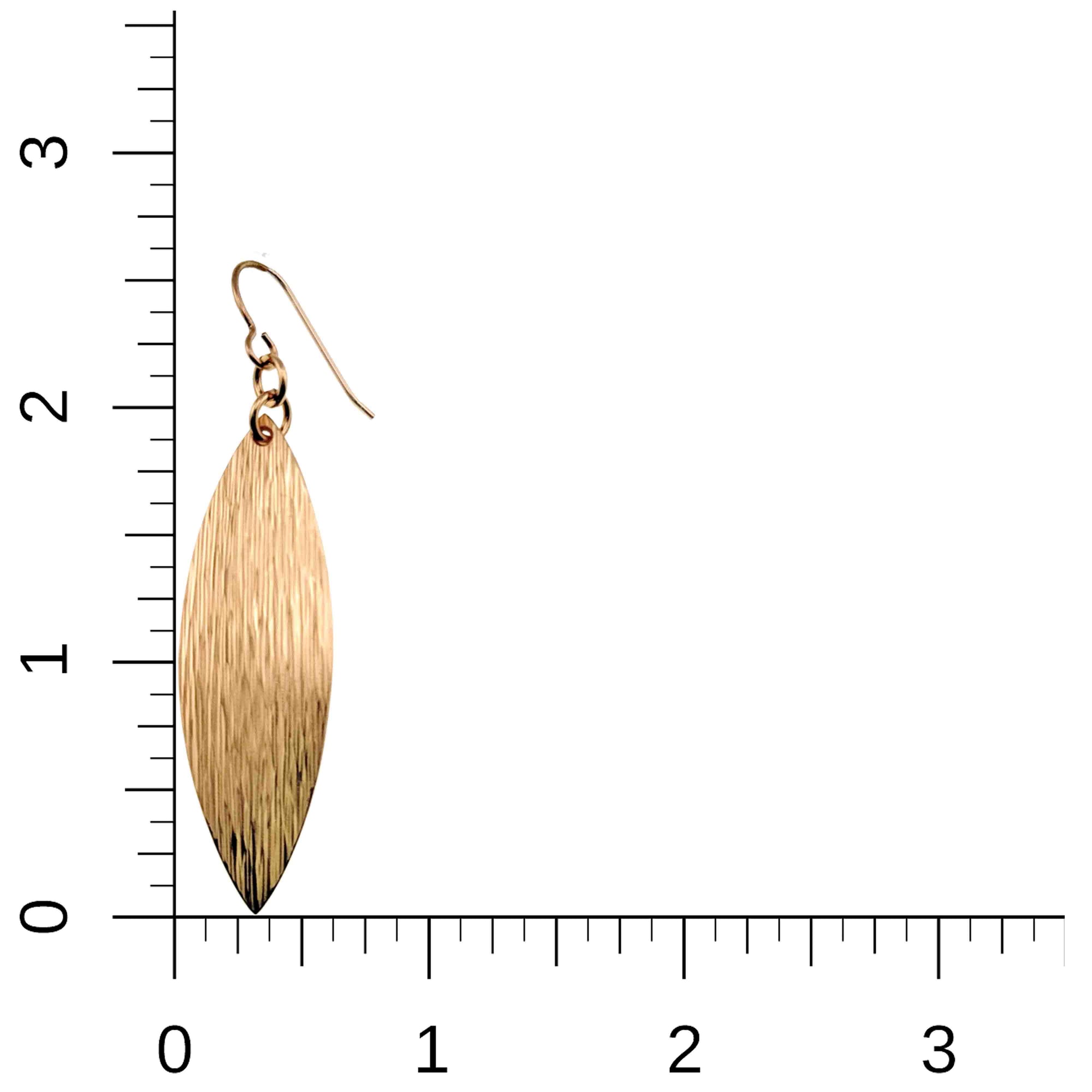 Bronze Bark Leaf Drop Earring next to a ruler for size reference on a white background