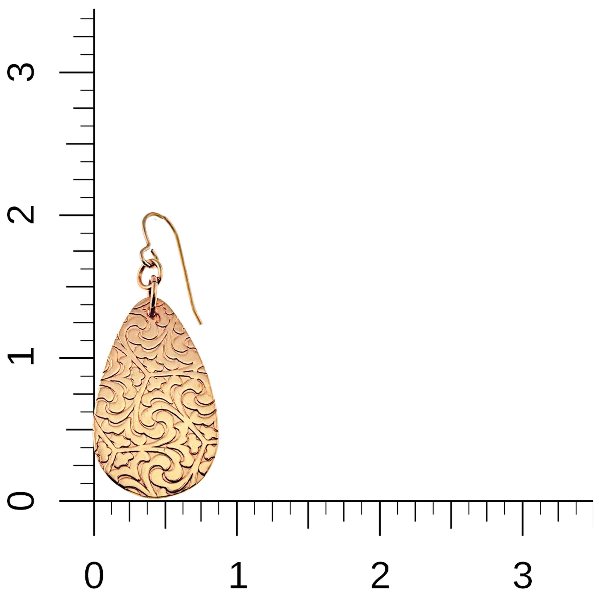 Bronze Damask Teardrop Earring on a ruler for scale