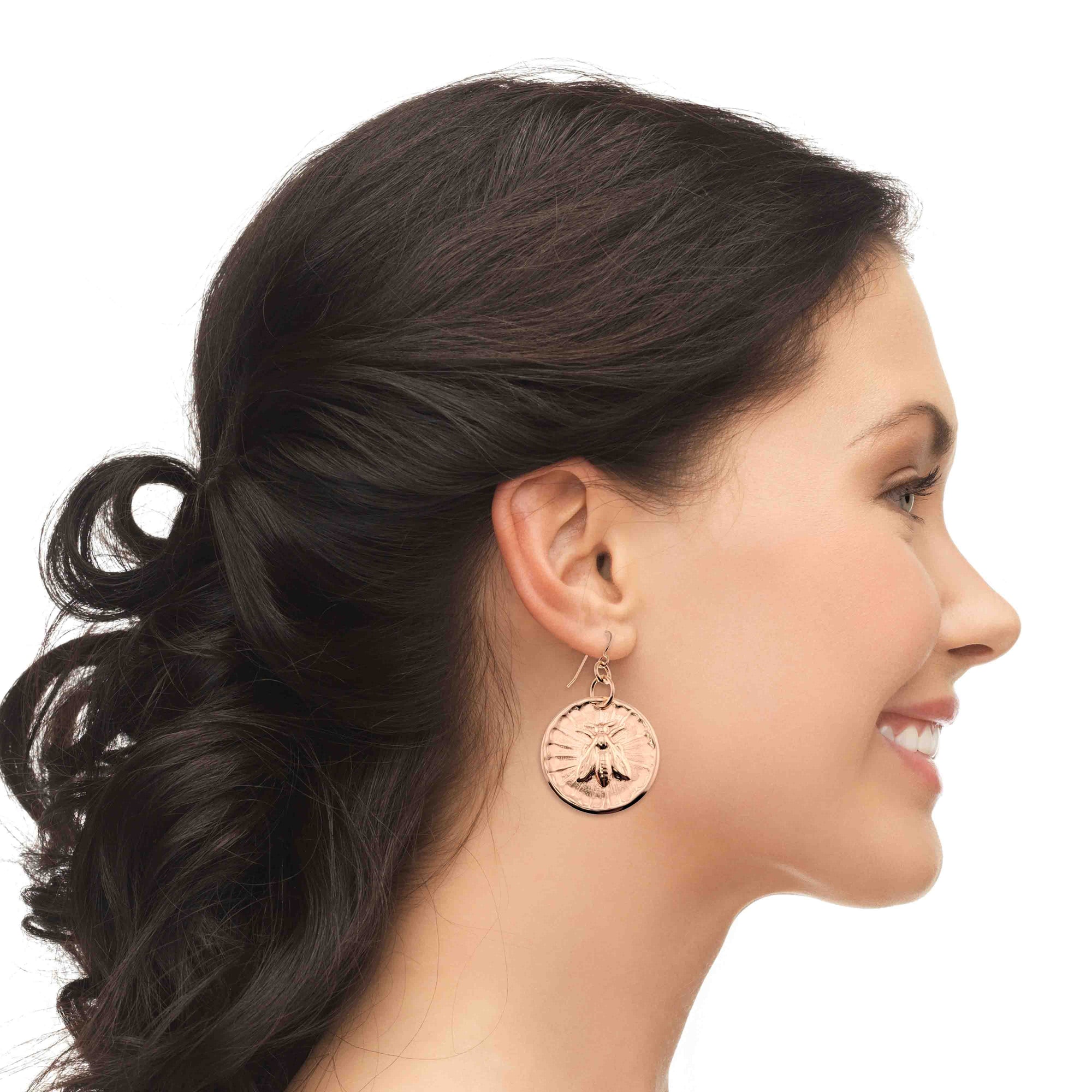 Woman wearing Bronze Queen Bee Disc Drop Earrings with a white background