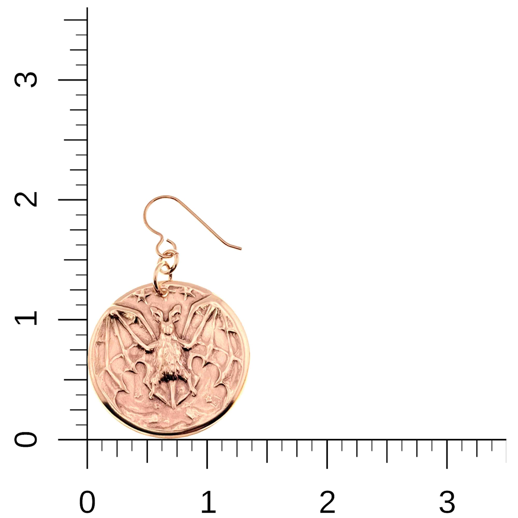 Bronze Vampire Bat Disc Dangle Earrings on a white background with a ruler for scale.