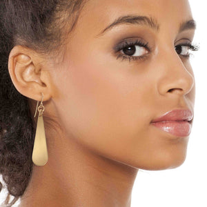 6 of 8: Chic Woman Wearing Brushed Bronze Long Teardrop Earrings