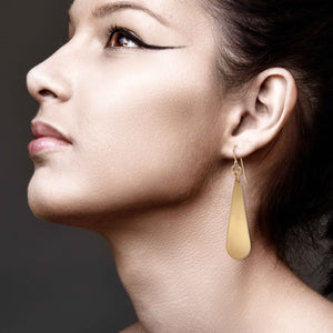 7 of 8: Stunning Woman Wearing Brushed Bronze Long Teardrop Earrings