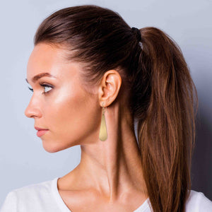 2 of 8: Woman In White T Wearing Brushed Bronze Long Teardrop Earrings