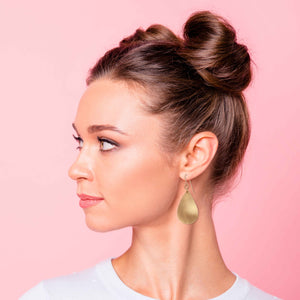 6 of 7: Fashionable Woman in White T Wearing Brushed Bronze Teardrop Earrings