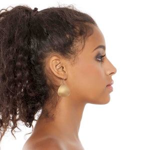 4 of 7: Chic Woman Wearing Brushed Bronze Triangular Drop Earrings