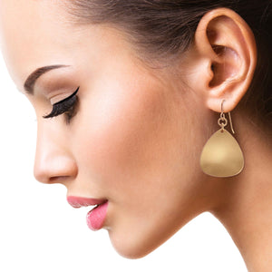 6 of 7: Stunning Woman Wearing Brushed Bronze Triangular Drop Earrings