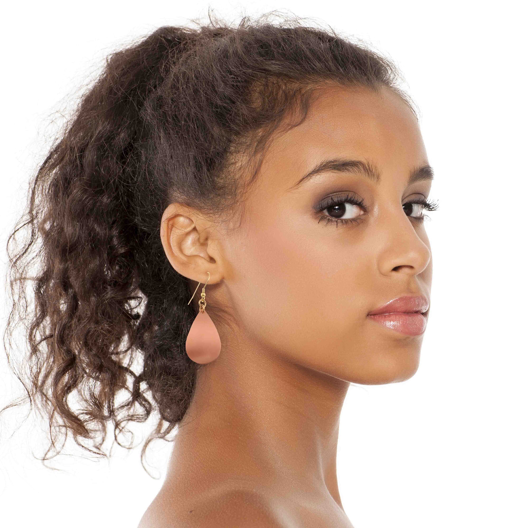 A Chic Woman Wearing Brushed Copper Teardrop Earrings