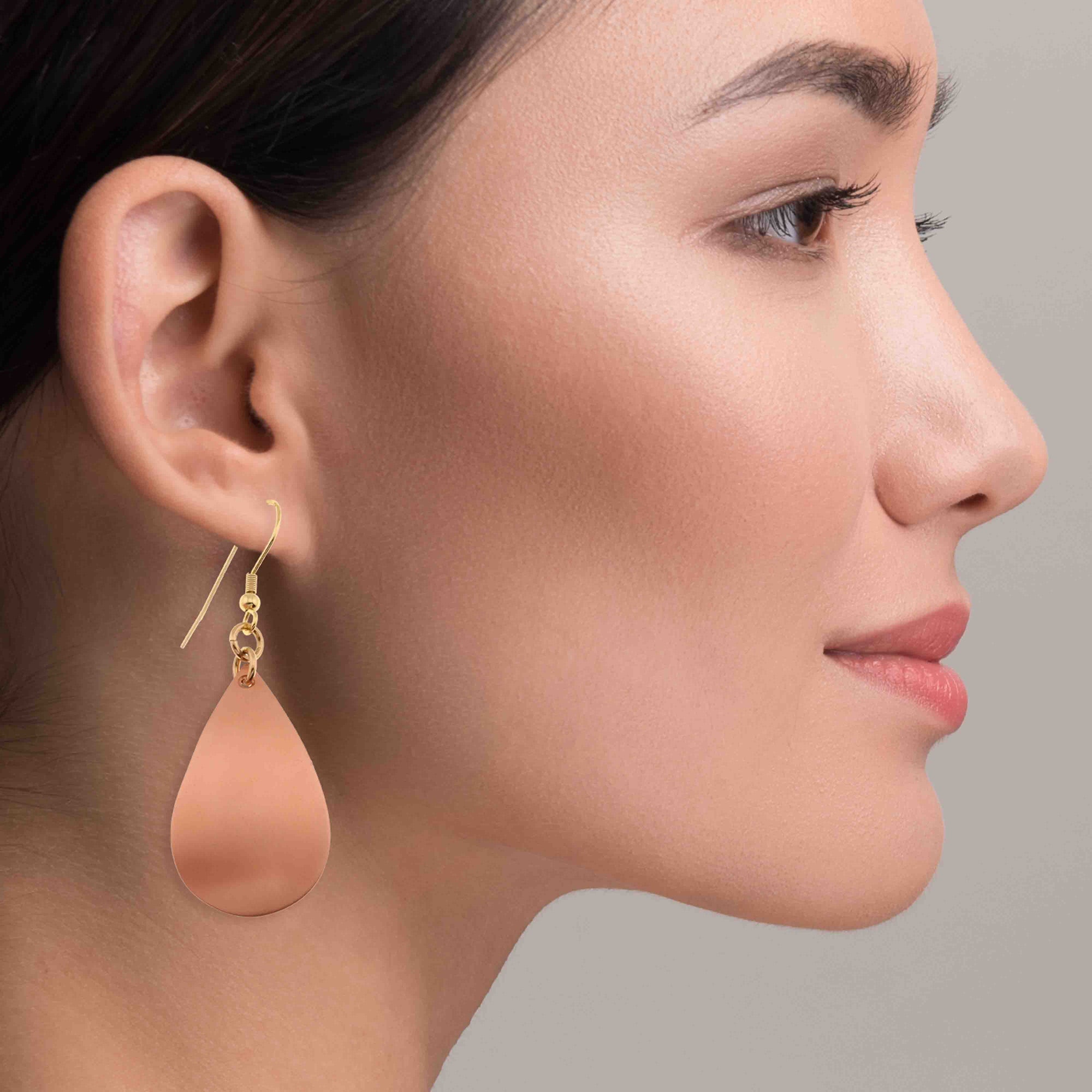A Fashionable Woman Wearing Brushed Copper Teardrop Earrings