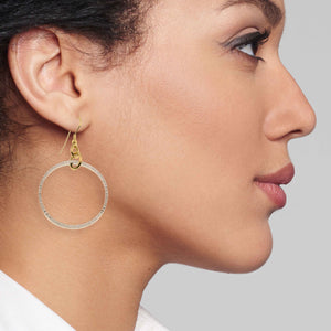 4 of 7: A Chic Woman Wearing Chased Rim Aluminum Hoop Earrings