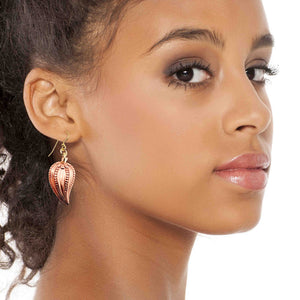 4 of 7: Close-up of a woman wearing Chili Pepper Copper Drop Earrings on a white background