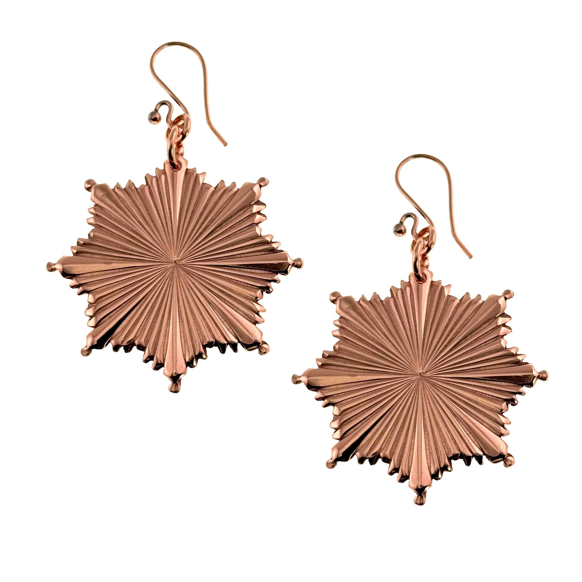 Christmas Starburst Copper Earrings on a white background