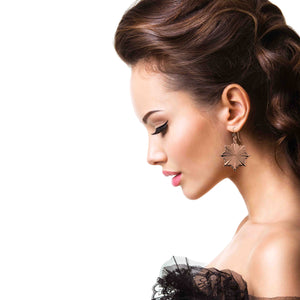 4 of 8: An Elegant Woman wearing a Christmas Starburst Copper Earring on a white background