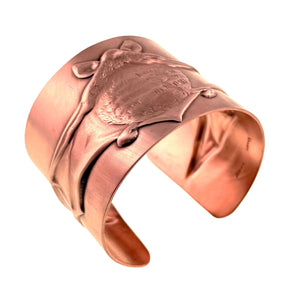 1 of 11: Angled view of the Copper Bat Cuff Bracelet showing the three dimensional flying bat motif wrapped across the brushed raw copper cuff. The raised wings, textured body, pointed ears, and smooth open bracelet shape can be seen clearly against a white background.