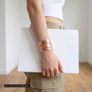 2 of 11: AI generated model wearing the wide Copper Bat Cuff Bracelet while holding a white laptop at her side. The warm copper statement cuff stands out against a white cropped top and khaki pants, showing the bracelet styled as a bold accessory for a clean casual outfit.