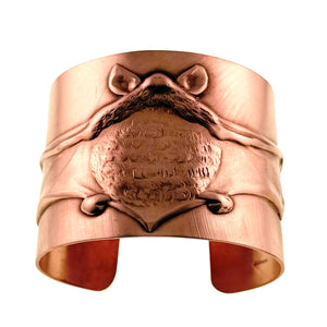 3 of 11: Front view of the Copper Bat Cuff Bracelet featuring a large raised flying bat centered across the wide brushed copper band. The bat has pointed ears, textured wings, and a sculpted body, while the open cuff ends are visible below against a white background.