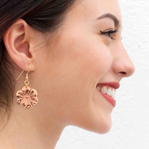 2 of 8: A Smiling Woman Wearing Copper Cherry Blossom Earrings