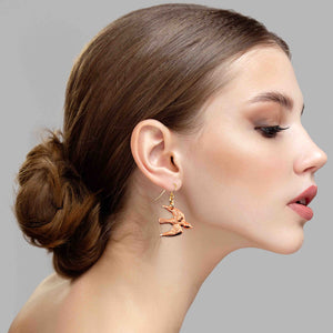 6 of 7: A Stunning Woman Wearing Copper Flying Swallow Earrings