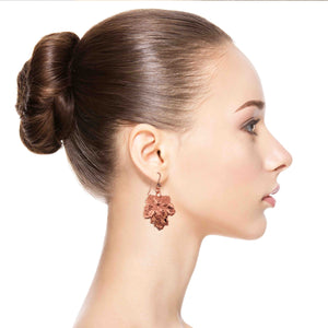 4 of 6: Woman wearing Grape Leaf Copper Dangle Earrings with a plain background