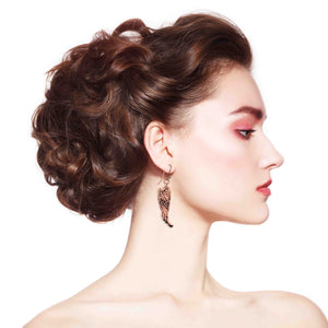 7 of 8: Woman with styled hair and wearing Copper Guardian Angel Wing Drop Earrings on a white background